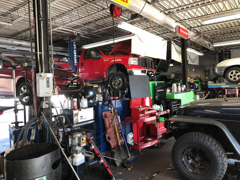 Inside the BTS service bays, vehicles up on lifts with a technician working